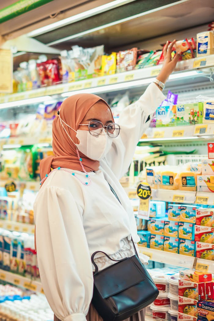 our-story Woman in hijab shopping in a supermarket in Jawa Barat, Indonesia.